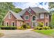 Stately brick home with a manicured lawn and mature trees at 1603 Drowning Creek Rd, Dacula, GA 30019