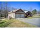 Charming home with a two-car garage, gabled roof, and landscaped front yard at 1603 Drowning Creek Rd, Dacula, GA 30019