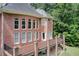 Stately brick home with multiple outdoor decks, providing scenic backyard views from several rooms at 1603 Drowning Creek Rd, Dacula, GA 30019