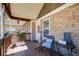 Charming front porch with stone accents, wood flooring, and cozy seating at 1603 Drowning Creek Rd, Dacula, GA 30019