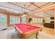 Game room with a pool table, carpeted floor, and natural light from many windows at 1603 Drowning Creek Rd, Dacula, GA 30019