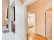 Hallway featuring hardwood floors, leading to a cozy bedroom with a ceiling fan, offering a glimpse of comfort at 1603 Drowning Creek Rd, Dacula, GA 30019