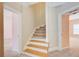 Bright hallway with stairs leading to the upper level and doorways to adjacent rooms at 1603 Drowning Creek Rd, Dacula, GA 30019