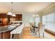 Eat-in kitchen features granite counters, a kitchen island, pendant lighting, and a sun-filled eating area at 1603 Drowning Creek Rd, Dacula, GA 30019
