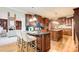 Spacious kitchen features wood cabinets, granite countertops, an island, and a breakfast bar with seating at 1603 Drowning Creek Rd, Dacula, GA 30019