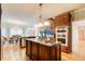 Gourmet kitchen features an island with a breakfast bar, stainless appliances, and a view of the dining room at 1603 Drowning Creek Rd, Dacula, GA 30019