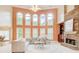 Bright and airy living room with large windows, stone fireplace, and open access to the dining area at 1603 Drowning Creek Rd, Dacula, GA 30019