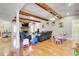 Expansive living room features wood beams, a fireplace, and hardwood floors at 1603 Drowning Creek Rd, Dacula, GA 30019