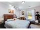 Serene bedroom featuring natural light, a cozy window seat and dark wood furniture with an area rug at 1603 Drowning Creek Rd, Dacula, GA 30019