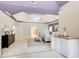 Spacious main bedroom featuring tray ceilings, carpet floors, and stylish decor at 1603 Drowning Creek Rd, Dacula, GA 30019