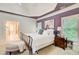 Comfortable bedroom with tray ceiling, large windows, and an ensuite bathroom with a view from the bed at 1603 Drowning Creek Rd, Dacula, GA 30019