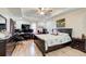 Main bedroom features modern bed, wood floors, and ample lighting at 1603 Drowning Creek Rd, Dacula, GA 30019