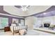 Main bedroom features a fireplace, sitting area, recessed lighting, and stylish tray ceiling at 1603 Drowning Creek Rd, Dacula, GA 30019