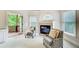 Cozy sitting area with fireplace, view of the deck, and plush seating in this luxurious main bedroom at 1603 Drowning Creek Rd, Dacula, GA 30019