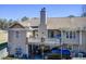 Rear exterior of a multi-story home with a large deck and covered parking at 1603 Drowning Creek Rd, Dacula, GA 30019