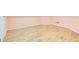 Room featuring new hardwood floors, white baseboards, and soft pink walls at 1603 Drowning Creek Rd, Dacula, GA 30019