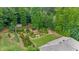 Aerial view of a home with a manicured lawn, an arbor, and verdant landscaping, nestled in a tree-filled neighborhood at 2196 Abbott Dr, Buford, GA 30519