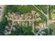 Aerial view of a neighborhood with well-maintained homes, lush trees, and manicured lawns at 2196 Abbott Dr, Buford, GA 30519