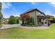 Backyard features a covered patio, mature trees, and a well-manicured lawn at 2196 Abbott Dr, Buford, GA 30519