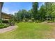 Lush backyard featuring a well-manicured lawn, landscaping, brick patio, and a charming arbor at 2196 Abbott Dr, Buford, GA 30519