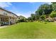 Spacious backyard with lush lawn, manicured landscaping, and an outdoor patio area at 2196 Abbott Dr, Buford, GA 30519