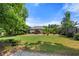 Expansive backyard with lush lawn, mature trees, and garden beds, offering a serene outdoor space at 2196 Abbott Dr, Buford, GA 30519