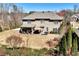 Backyard view features a large patio area, beautiful landscaping, and wooded views at 2196 Abbott Dr, Buford, GA 30519