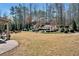 A spacious backyard with a patio, seating area and manicured landscaping, perfect for outdoor activities at 2196 Abbott Dr, Buford, GA 30519