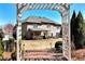 View of the home's exterior and backyard featuring a brick pathway and outdoor seating area at 2196 Abbott Dr, Buford, GA 30519