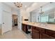 Bathroom with double vanity, large mirror, tile floor and chandelier at 2196 Abbott Dr, Buford, GA 30519