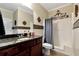 Bathroom featuring dark wood cabinetry, granite countertops and shower and tub combo at 2196 Abbott Dr, Buford, GA 30519