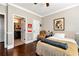 Cozy bedroom features a connected bathroom and hardwood floors at 2196 Abbott Dr, Buford, GA 30519