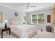 Bright bedroom features a large window, neutral walls, and a white ceiling fan at 2196 Abbott Dr, Buford, GA 30519