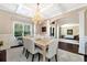 Elegant dining room with coffered ceilings, chandelier, wainscoting, and views into the formal living room at 2196 Abbott Dr, Buford, GA 30519