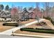 Beautiful two-story home featuring manicured landscaping, a curved driveway, and mature trees at 2196 Abbott Dr, Buford, GA 30519