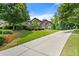 Spacious home with a long driveway, lush lawn, and mature trees at 2196 Abbott Dr, Buford, GA 30519