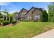 Beautiful two-story brick home with well-manicured lawn and mature trees at 2196 Abbott Dr, Buford, GA 30519