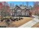 An inviting two-story brick home showcasing a well-maintained lawn and established landscaping at 2196 Abbott Dr, Buford, GA 30519