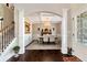Welcoming foyer with hardwood floors, staircase with wrought iron railing, and views into the formal dining room at 2196 Abbott Dr, Buford, GA 30519