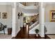 Open foyer featuring hardwood floors, tall ceilings, wrought iron accents, and views into the living room at 2196 Abbott Dr, Buford, GA 30519