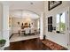 Elegant foyer with dark hardwood floors, leading to a formal dining room with a coffered ceiling and chandelier at 2196 Abbott Dr, Buford, GA 30519