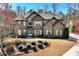Beautiful brick home showcasing architectural details and a well-maintained lawn in a serene setting at 2196 Abbott Dr, Buford, GA 30519