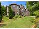 Elegant brick and siding home with mature trees and manicured lawn at 2196 Abbott Dr, Buford, GA 30519