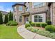 Charming brick home with lush landscaping and curved walkway leading to the covered front entrance at 2196 Abbott Dr, Buford, GA 30519