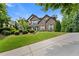 Stunning two-story brick home featuring lush landscaping and a long driveway at 2196 Abbott Dr, Buford, GA 30519