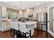 Modern kitchen with white cabinets, stainless steel appliances, center island with seating, and hardwood floors at 2196 Abbott Dr, Buford, GA 30519