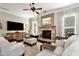 Living room showcases a stone fireplace, large windows, and neutral-toned decor at 2196 Abbott Dr, Buford, GA 30519