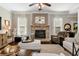 Living room with a stone fireplace, large windows, and wood flooring at 2196 Abbott Dr, Buford, GA 30519