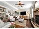 Comfortable living room with stone fireplace, hardwood floors, and views of the staircase at 2196 Abbott Dr, Buford, GA 30519