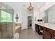 Elegant main bathroom with a glass-enclosed shower, soaking tub, and chandelier at 2196 Abbott Dr, Buford, GA 30519